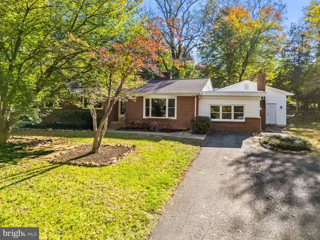 wooden floor fireplace and windows in an empty room
