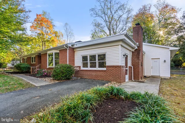 a view of empty room with wooden floor and fireplace