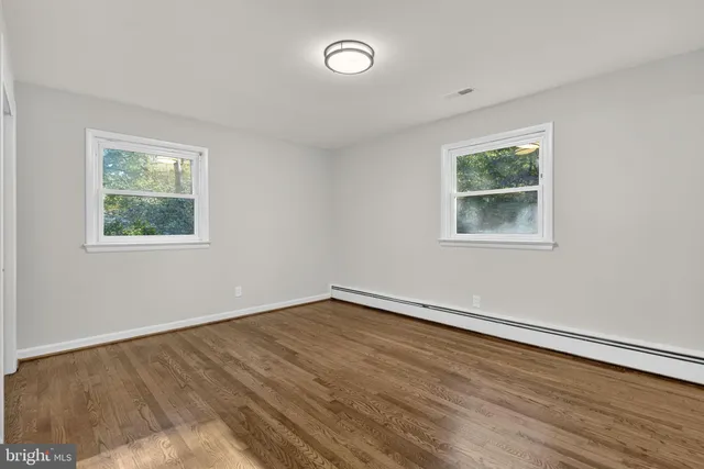 a white toilet sitting next to a window