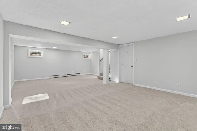 a view of a house with a big yard plants and large trees