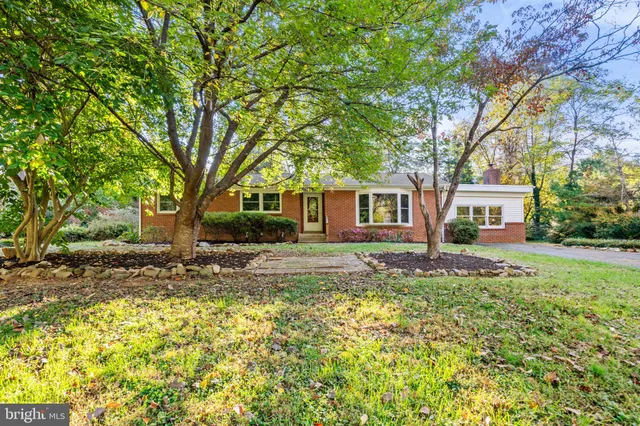 a front view of a house with a yard table and chairs