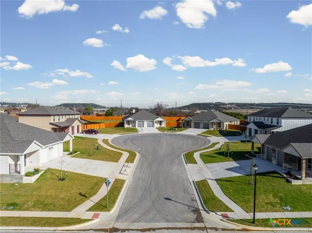 an aerial view of a house with a swimming pool