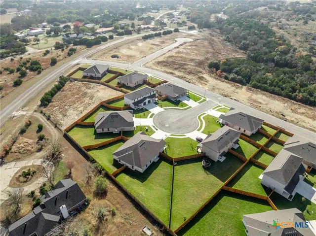 an aerial view of residential houses with outdoor space