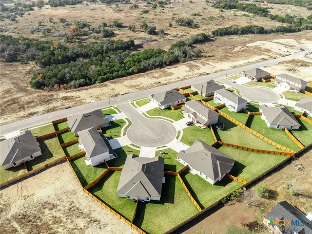 an aerial view of residential houses with outdoor space