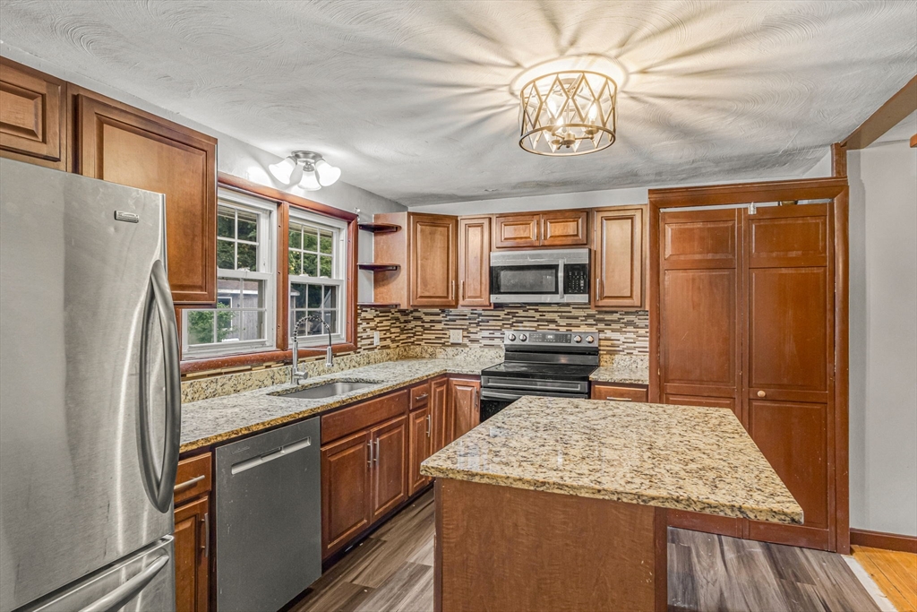 21 Annette Road Brockton, MA 02302 - Photo 12 of 29 a kitchen with stainless steel appliances granite countertop a sink stove and refrigerator