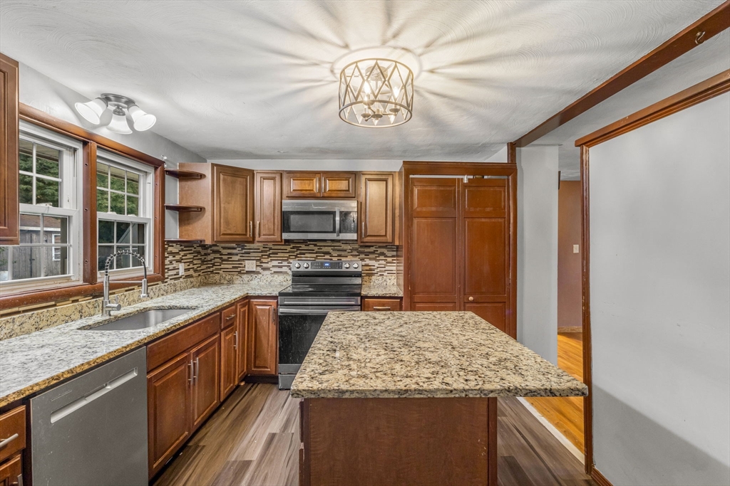 21 Annette Road Brockton, MA 02302 - Photo 14 of 29 a kitchen with stainless steel appliances granite countertop a sink stove and refrigerator