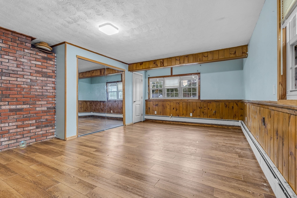 21 Annette Road Brockton, MA 02302 - Photo 19 of 29 a view of a hallway with wooden floor and fireplace
