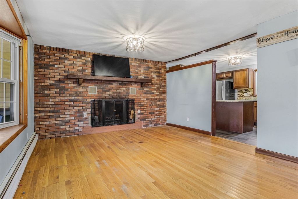 21 Annette Road Brockton, MA 02302 - Photo 10 of 29 a view of empty room with a fireplace and a flat screen tv