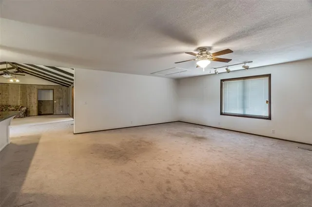 a view of a livingroom with a ceiling fan and window