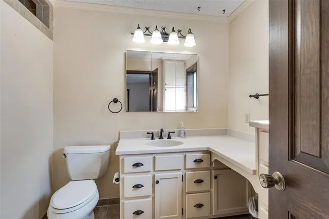 a bathroom with a sink a toilet and mirror