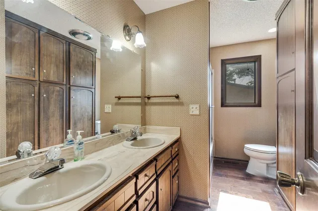 a bathroom with a sink double vanity and a toilet