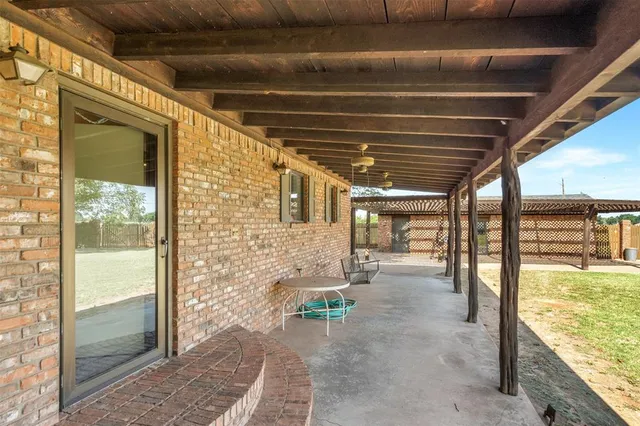 a view of a porch with a table and chairs