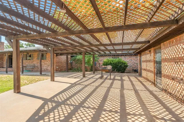 a view of a porch with a table and chairs