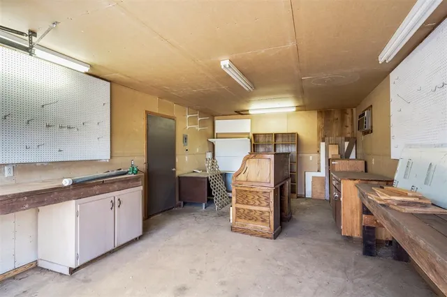 a kitchen with refrigerator and cabinets