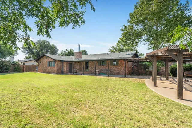 a swimming pool with outdoor seating and yard