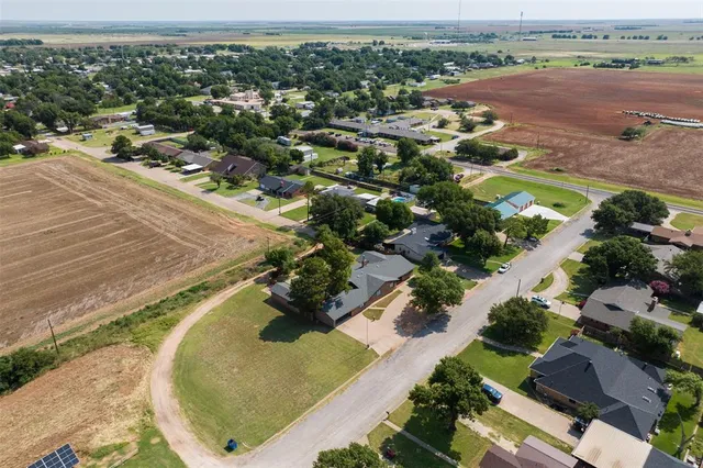 an aerial view of a house with a yard lake and mountain view