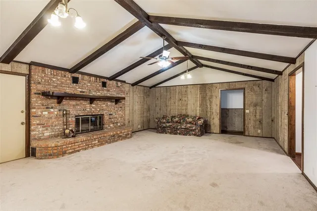 a view of a livingroom with a fireplace and a chandelier