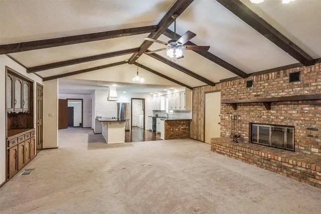 a view of a livingroom with fireplace and cabinet