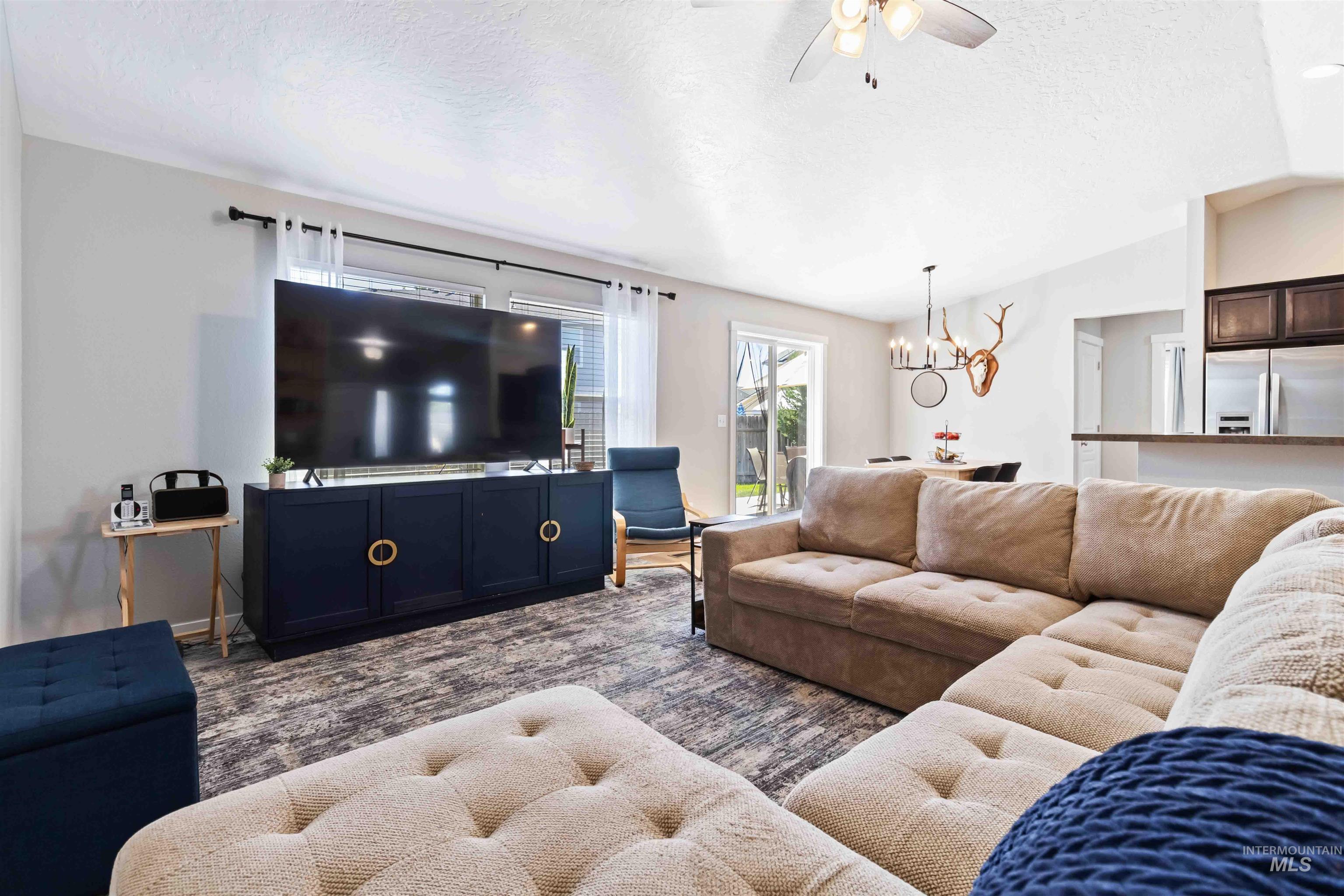 588 Gateway Avenue Middleton, ID 83644 - Photo 11 of 42 Living room featuring ceiling fan and suspended lighting