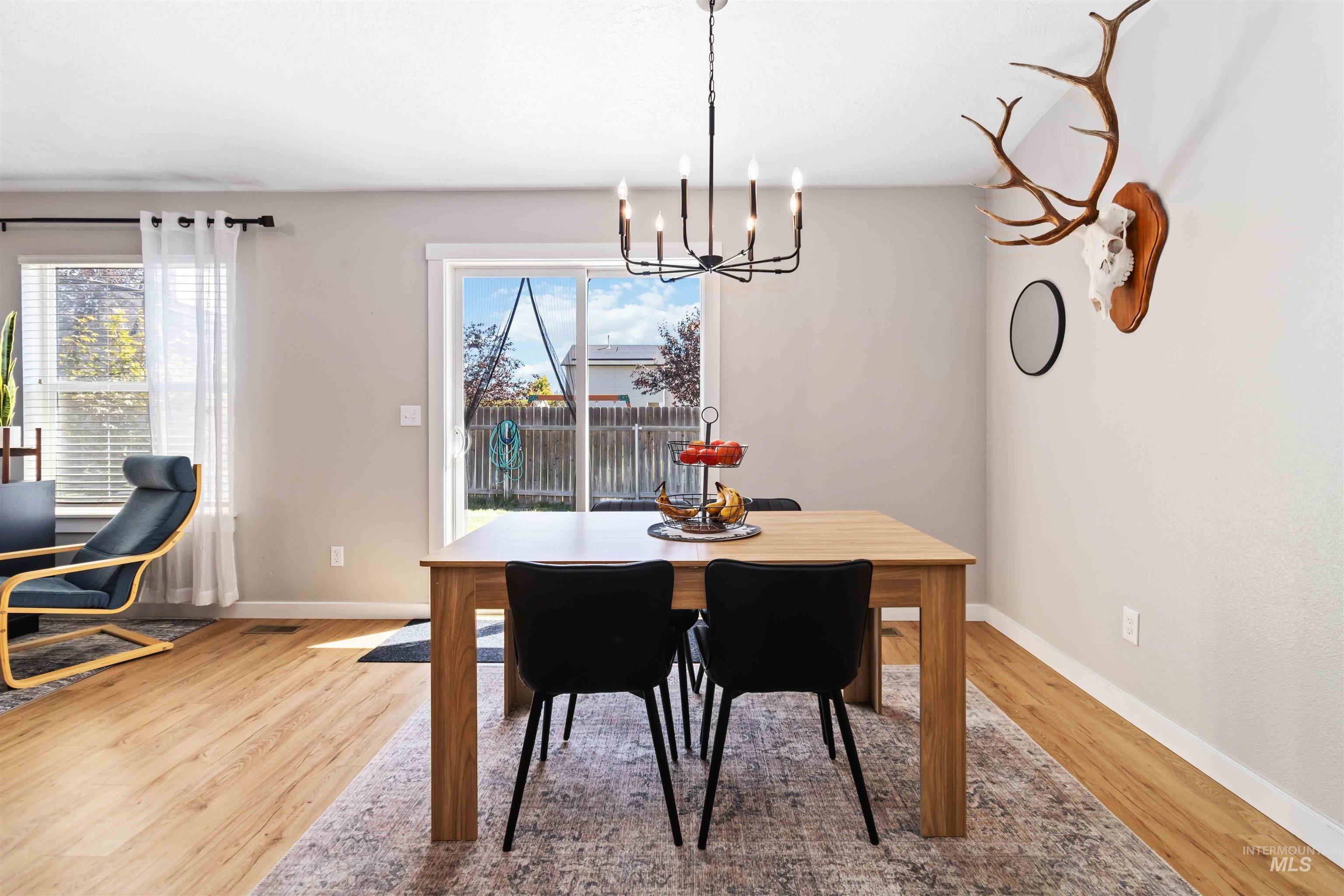 588 Gateway Avenue Middleton, ID 83644 - Photo 16 of 42 Dining area featuring light wood-style floors, plenty of natural light, and suspended lighting