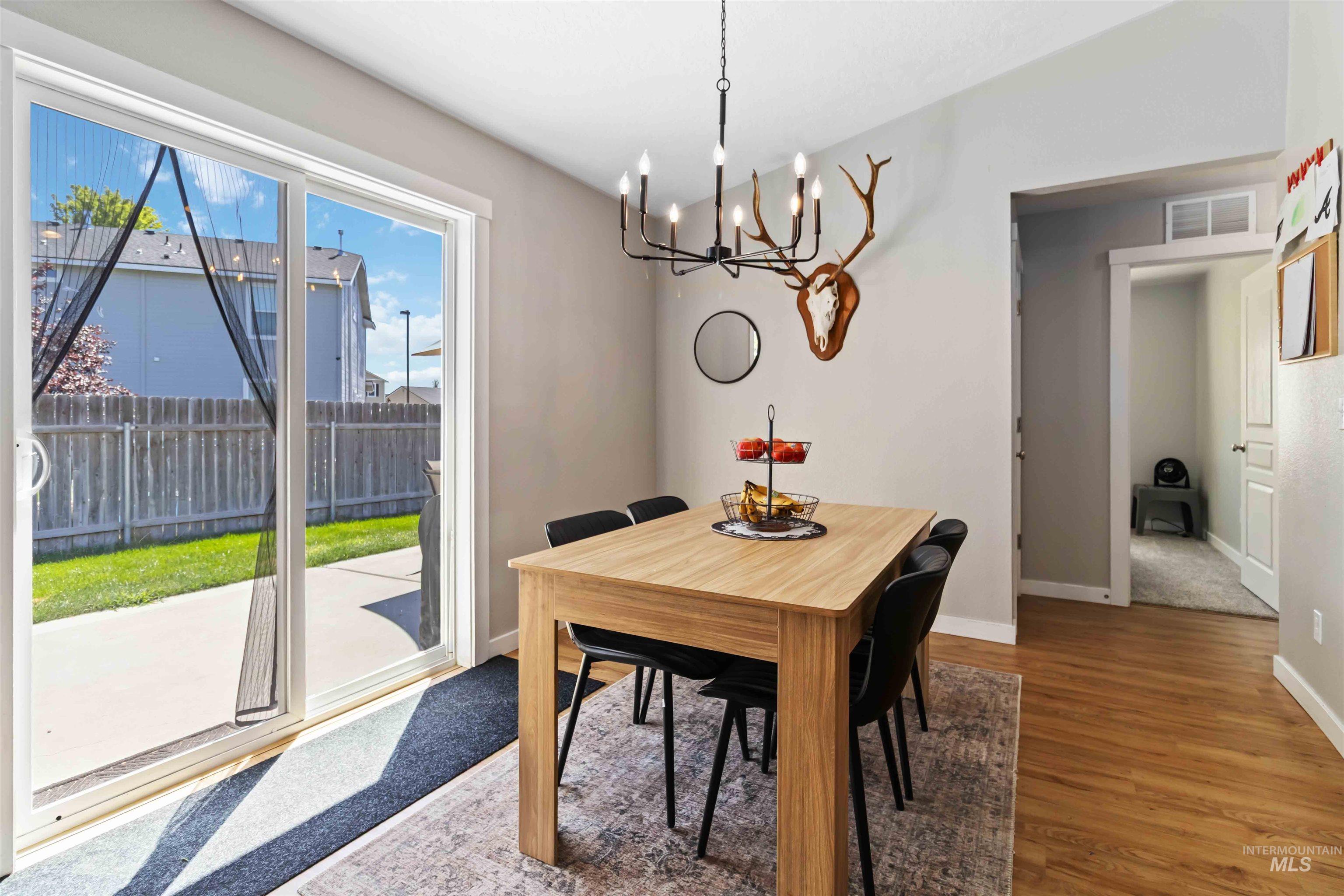 588 Gateway Avenue Middleton, ID 83644 - Photo 17 of 42 Dining area featuring wood finished floors and hanging lights