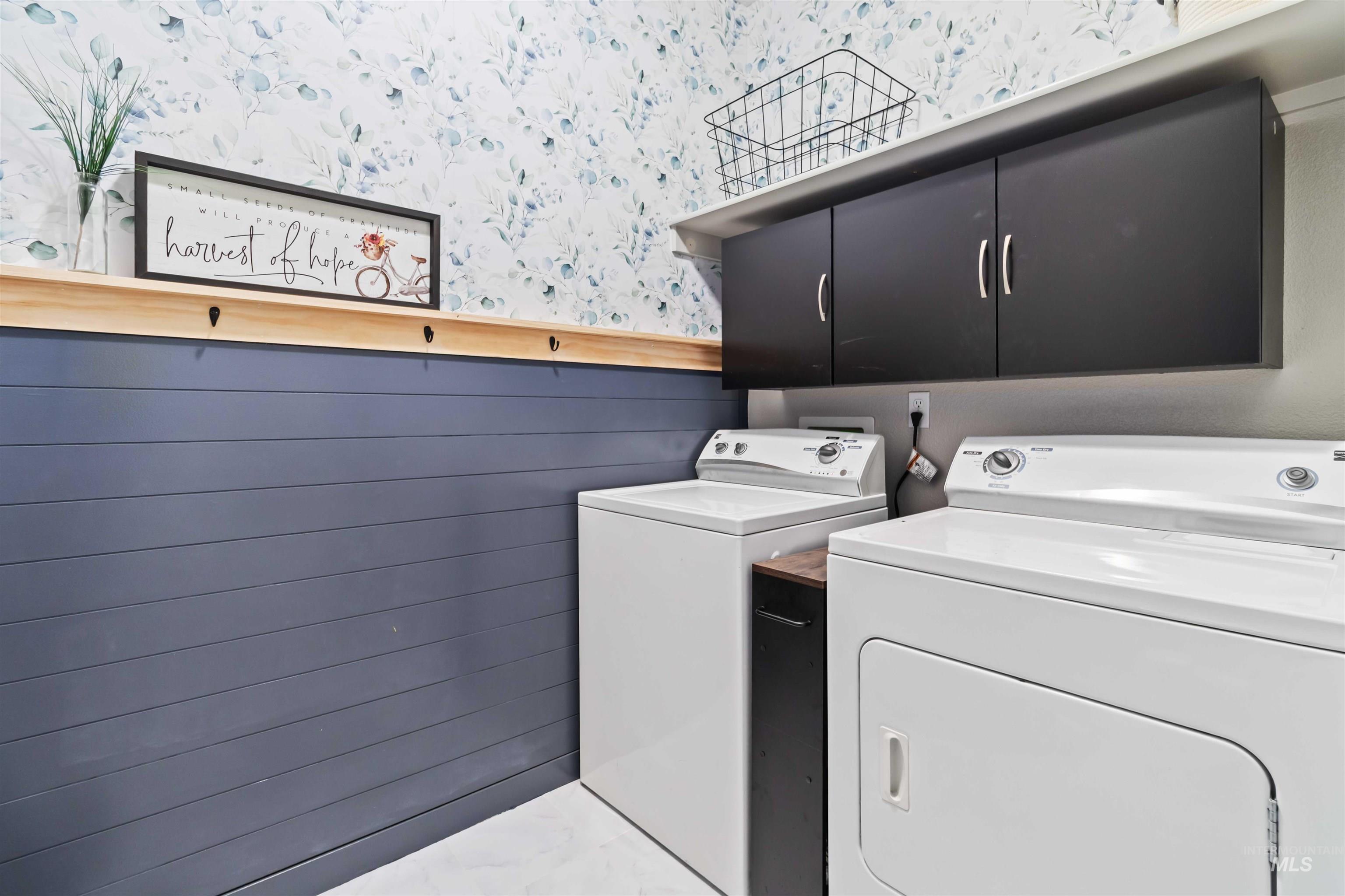 588 Gateway Avenue Middleton, ID 83644 - Photo 21 of 42 Laundry room with wallpapered walls, washer and clothes dryer, cabinet space, and a wainscoted wall