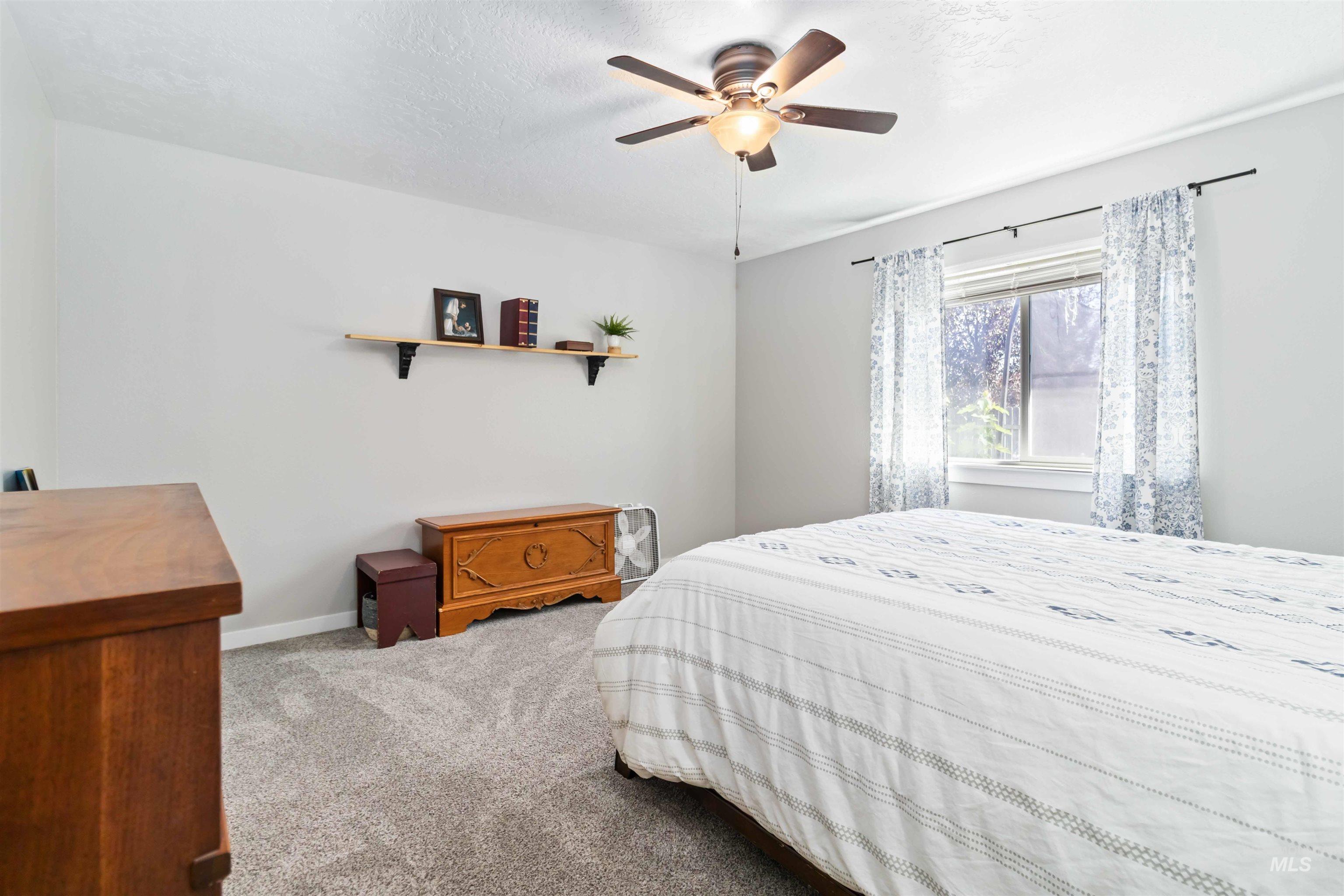 588 Gateway Avenue Middleton, ID 83644 - Photo 28 of 42 Bedroom featuring light carpet, ceiling fan, and a textured ceiling