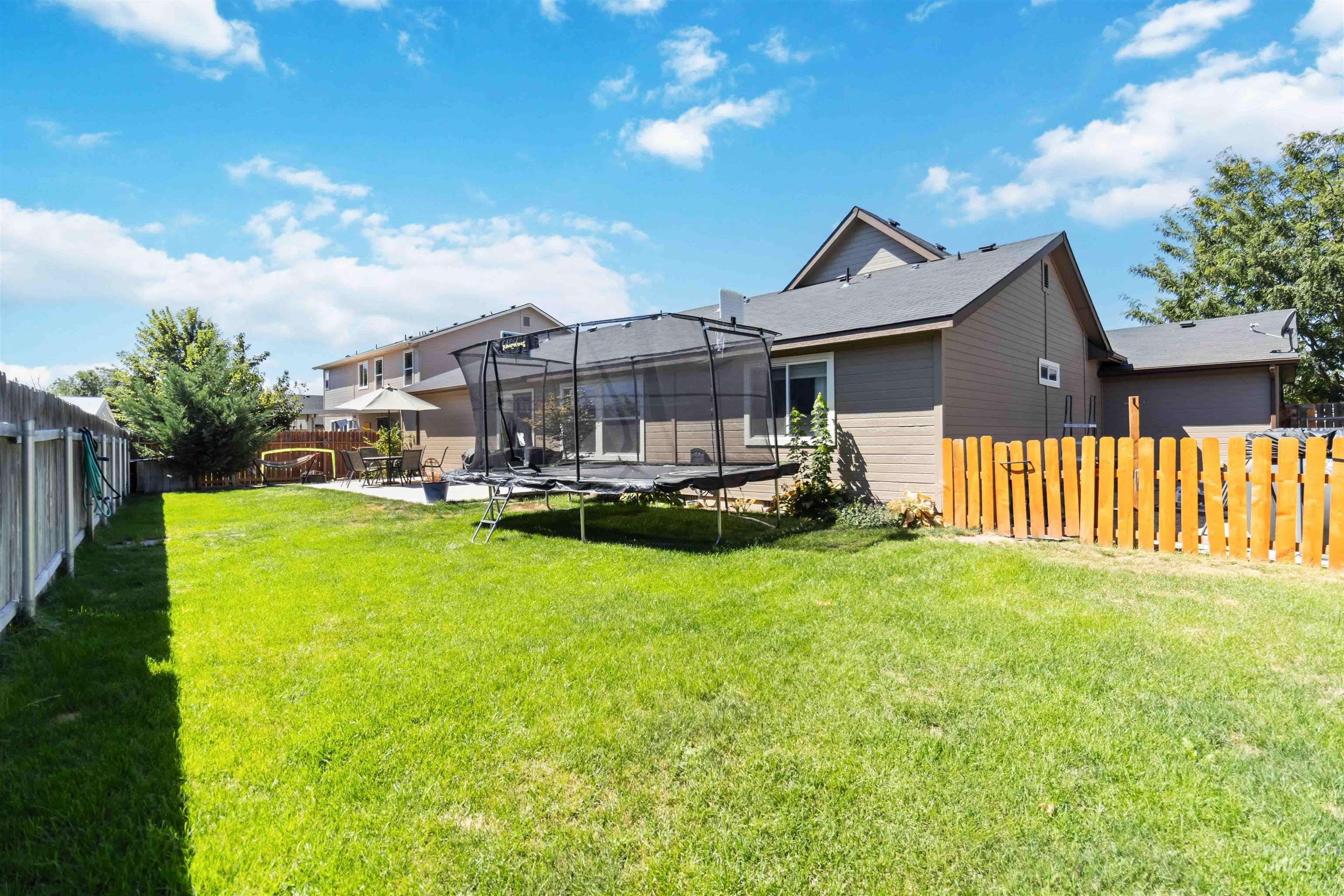588 Gateway Avenue Middleton, ID 83644 - Photo 38 of 42 Rear view of house with a trampoline, a fenced backyard, and a patio