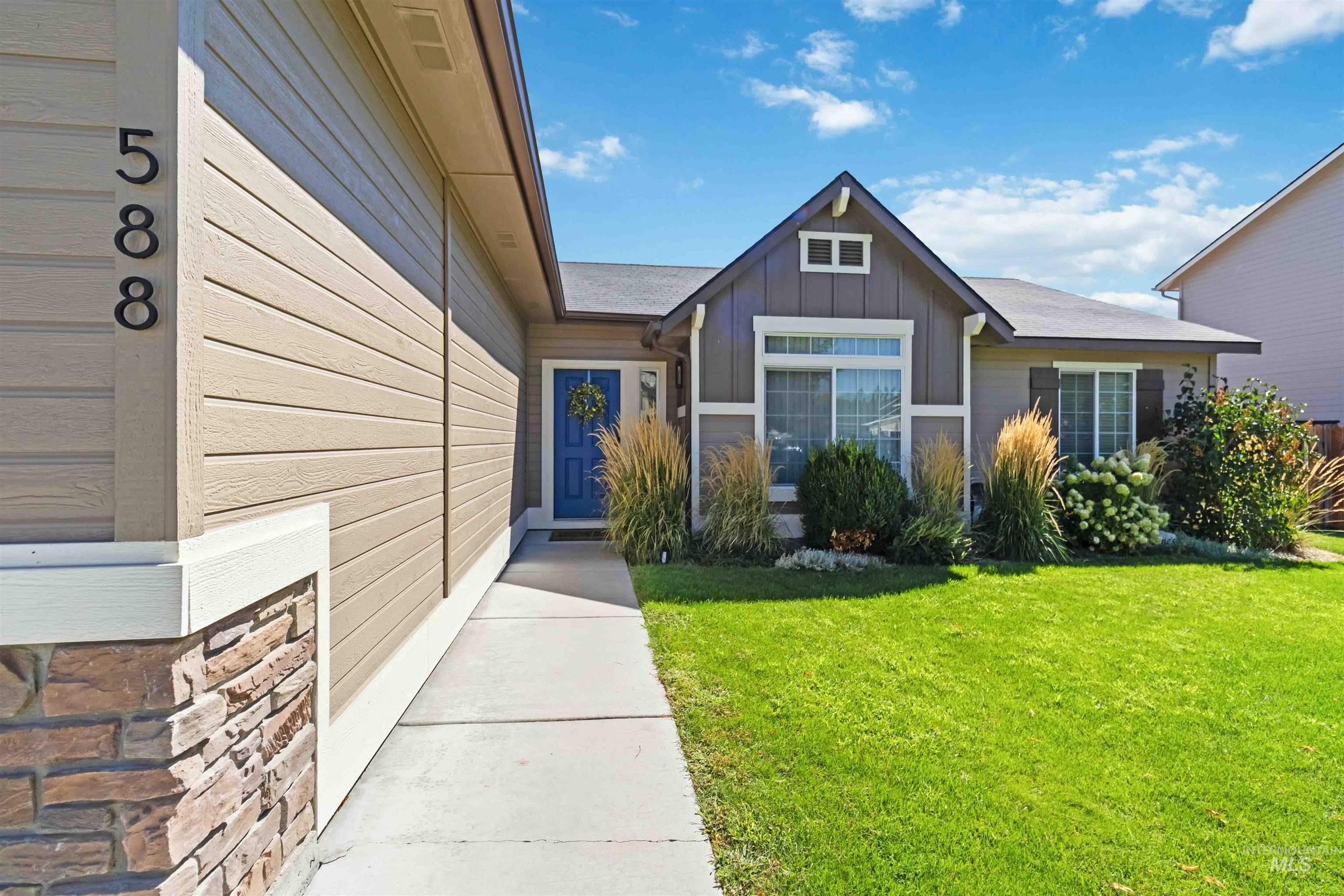 588 Gateway Avenue Middleton, ID 83644 - Photo 4 of 42 Doorway to property featuring a yard and board and batten siding