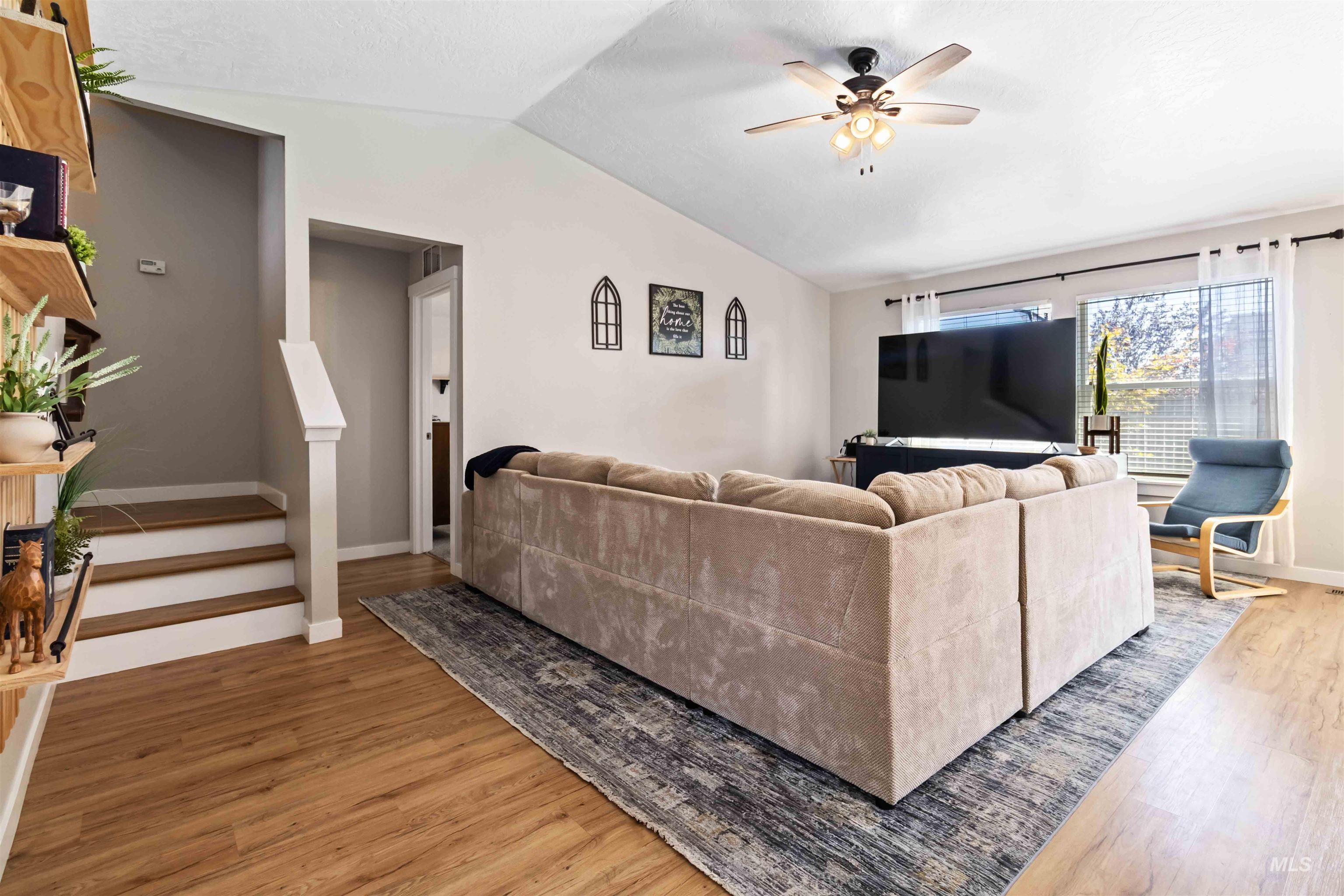 588 Gateway Avenue Middleton, ID 83644 - Photo 10 of 42 Living area featuring lofted ceiling, a ceiling fan, and light wood-style floors