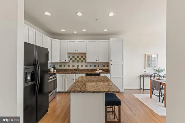 a kitchen with kitchen island a refrigerator stove and microwave