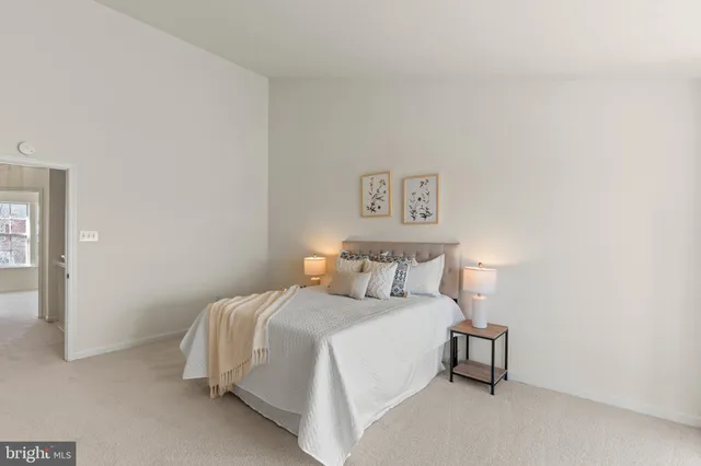 a bedroom with a bed and a night stand