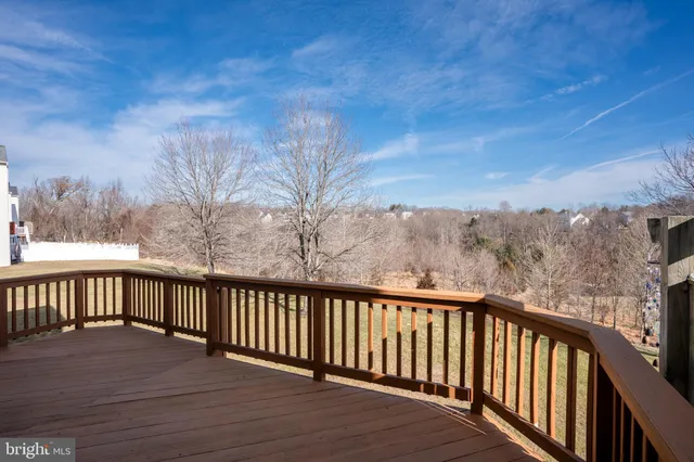a balcony with wooden floor and fence