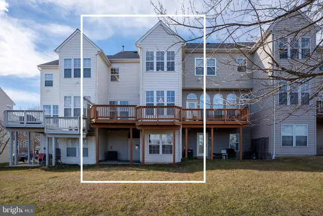 a view of a house with a patio and a yard