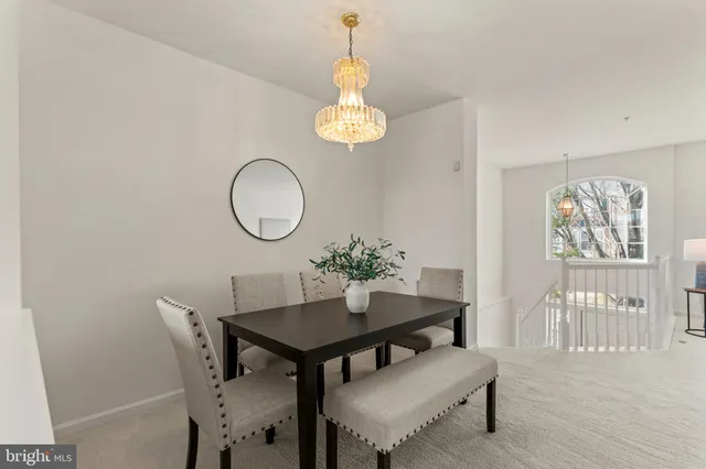a dining room with furniture and a window