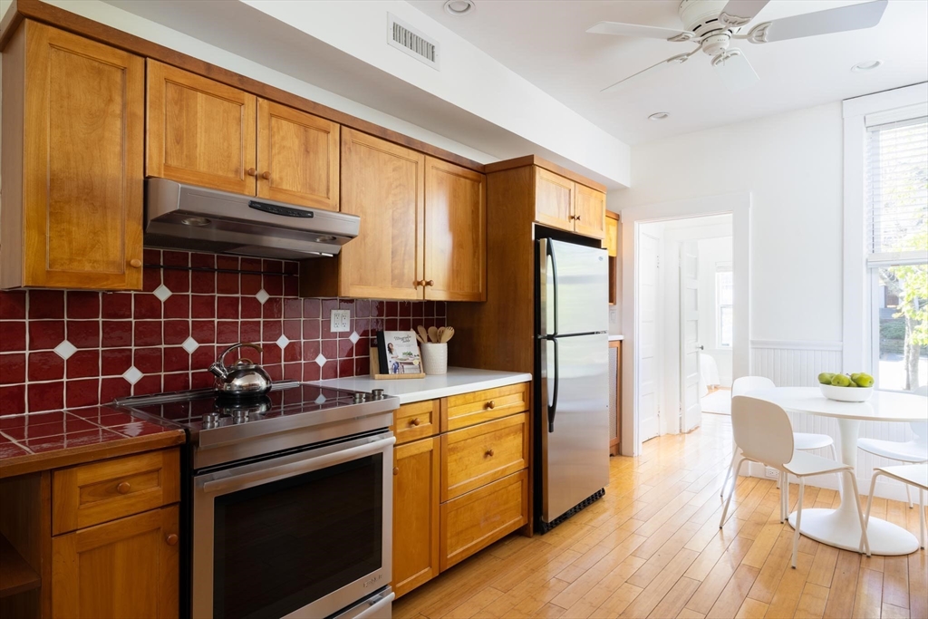 38 Garrison Road, Unit 2 Brookline, MA 02445 - Photo 6 of 18 a kitchen with a stove window and cabinets