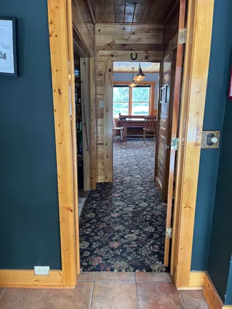 a hallway with a view of living room