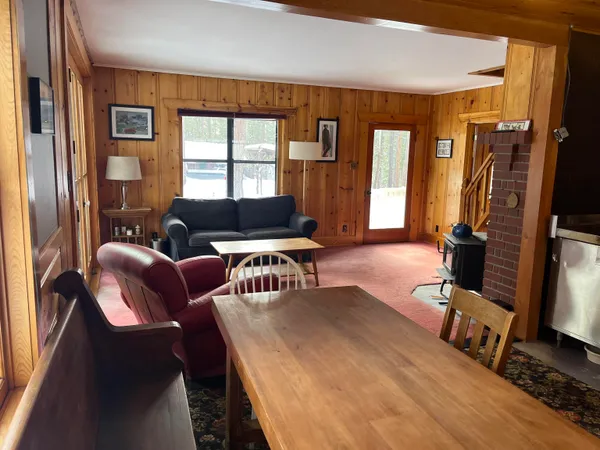 a living room with furniture a flat screen tv and a large window