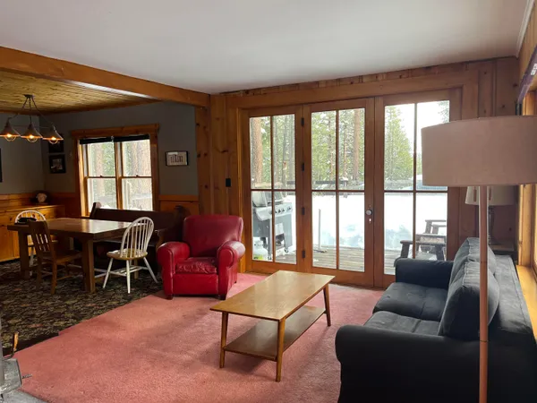 a living room with furniture and a floor to ceiling window