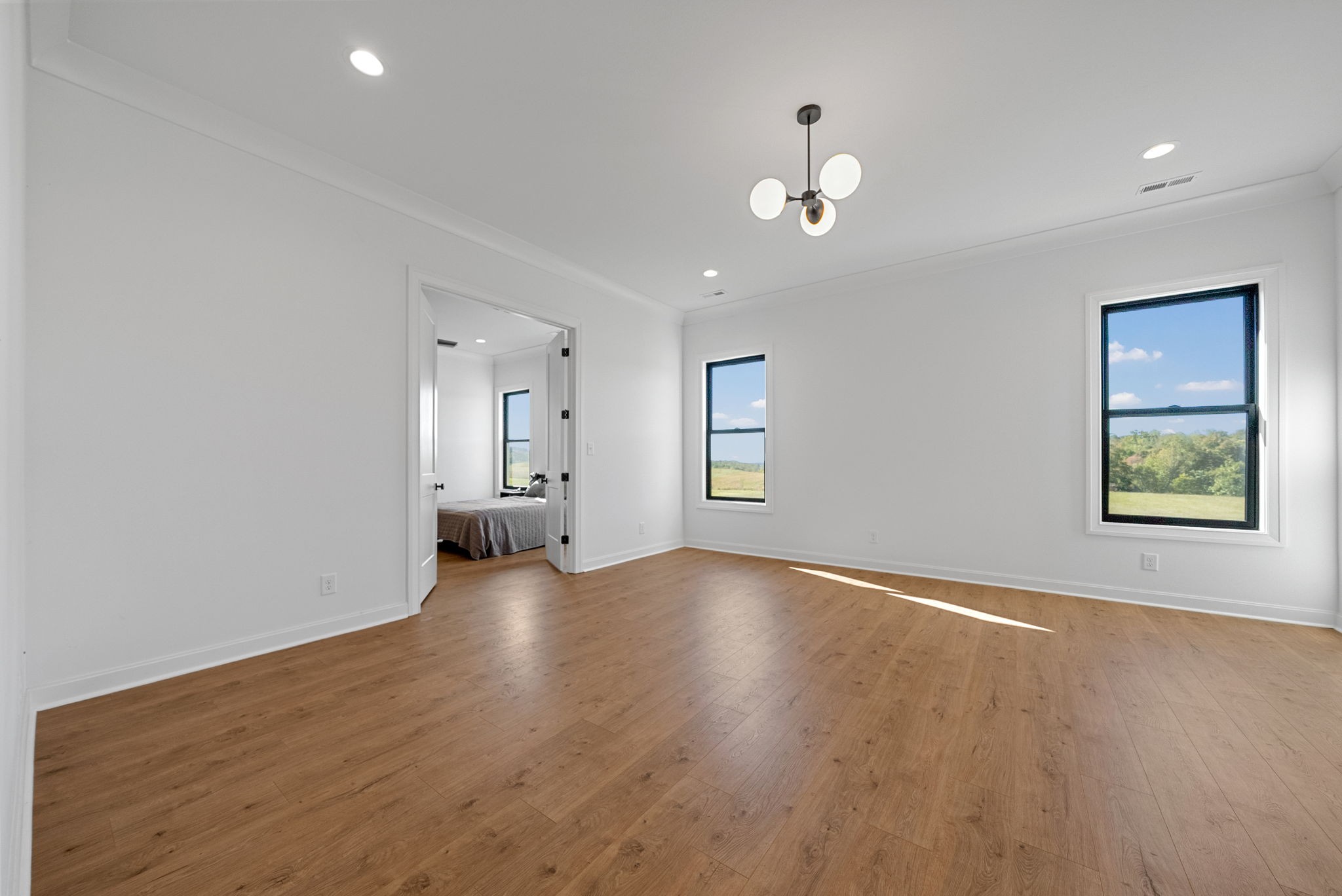 1914 Hickory Point Road Clarksville, TN 37043 - Photo 29 of 75 an empty room with wooden floor chandelier and windows