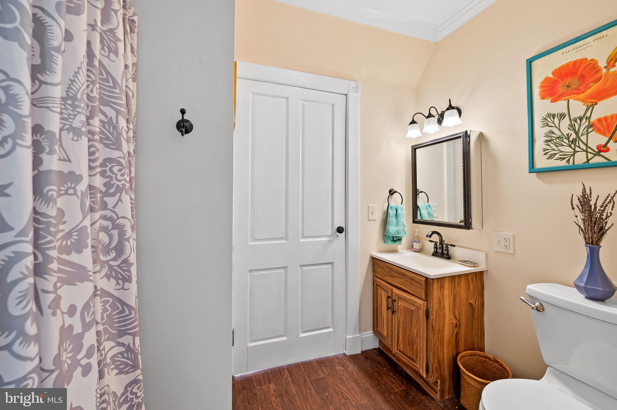 1018 Windsor Road Baltimore, MD 21208 - Photo 27 of 50 a bathroom with a double vanity sink and mirror