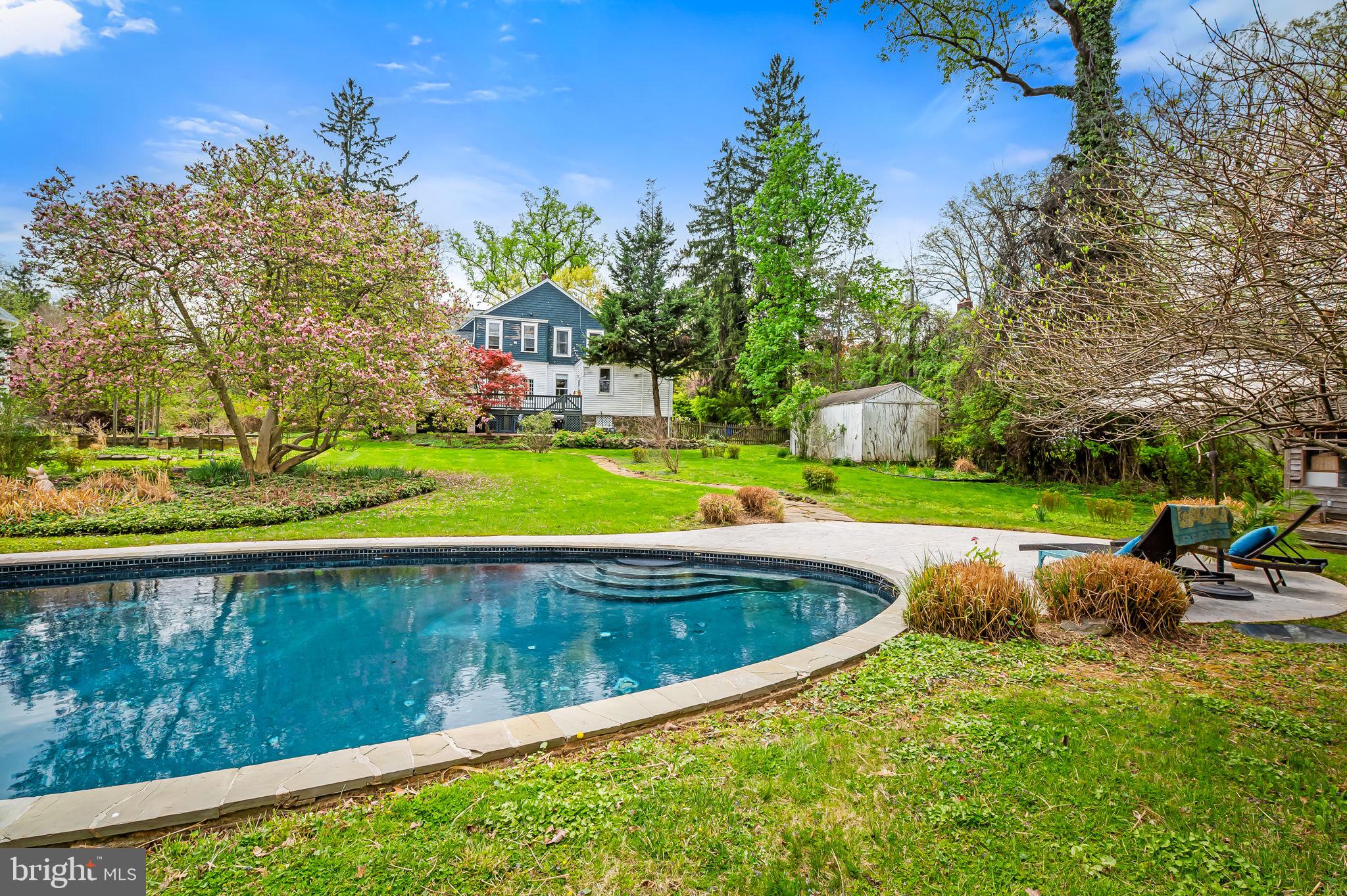 1018 Windsor Road Baltimore, MD 21208 - Photo 3 of 50 a view of swimming pool with lawn chairs and plants