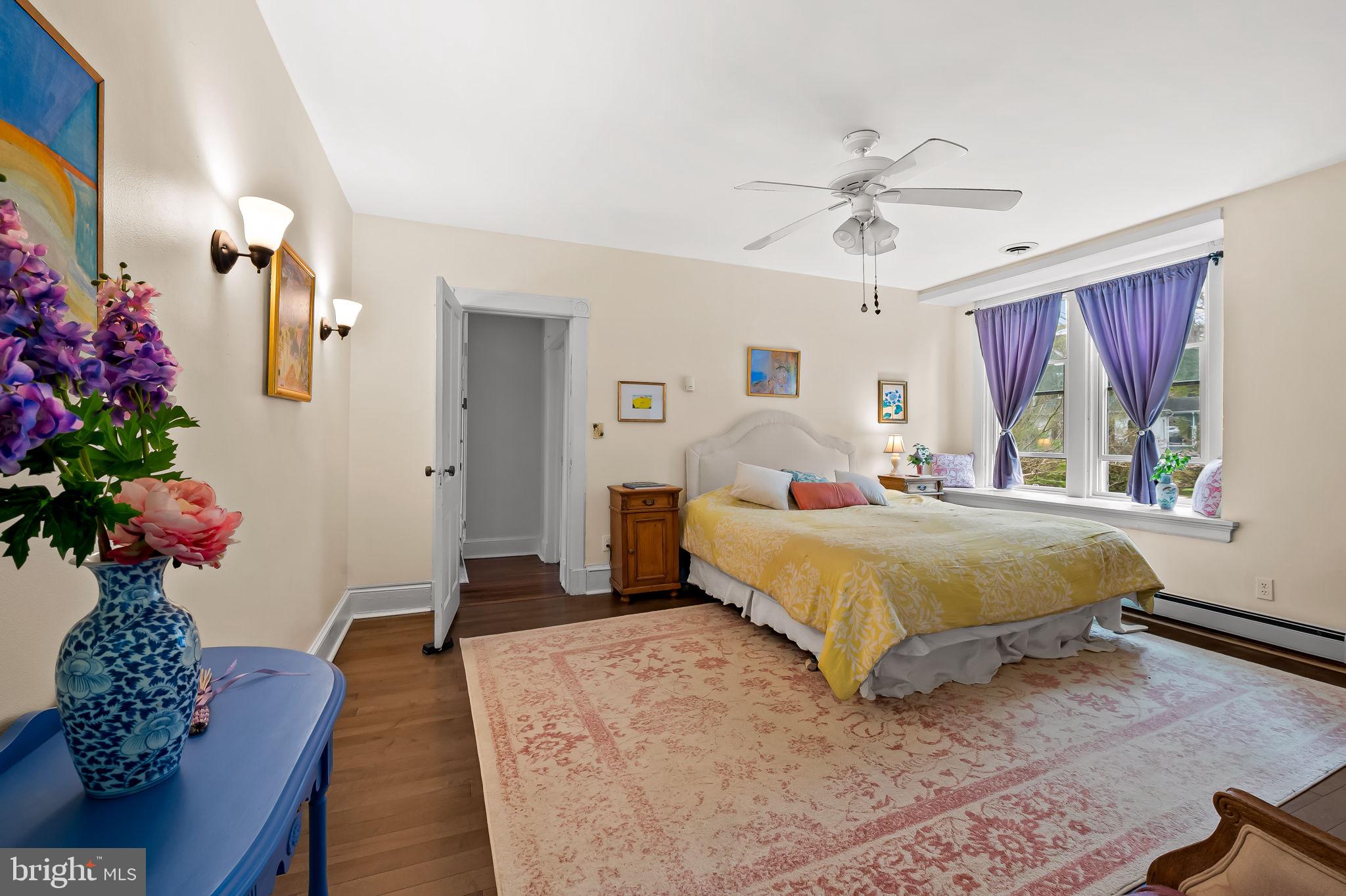 1018 Windsor Road Baltimore, MD 21208 - Photo 31 of 50 a bedroom with a large bed potted plant and a window