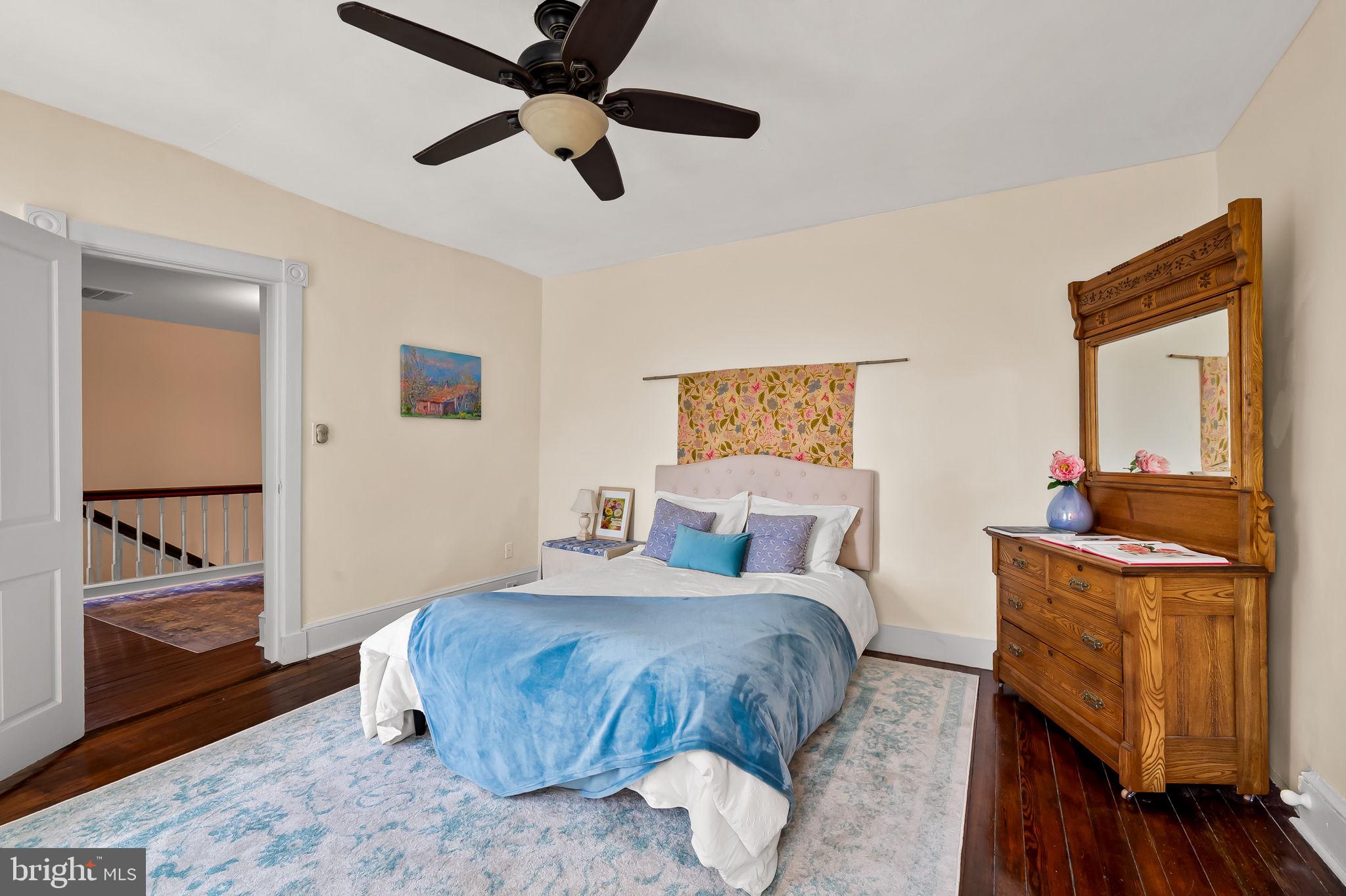 1018 Windsor Road Baltimore, MD 21208 - Photo 35 of 50 a bedroom with a bed and wooden floor