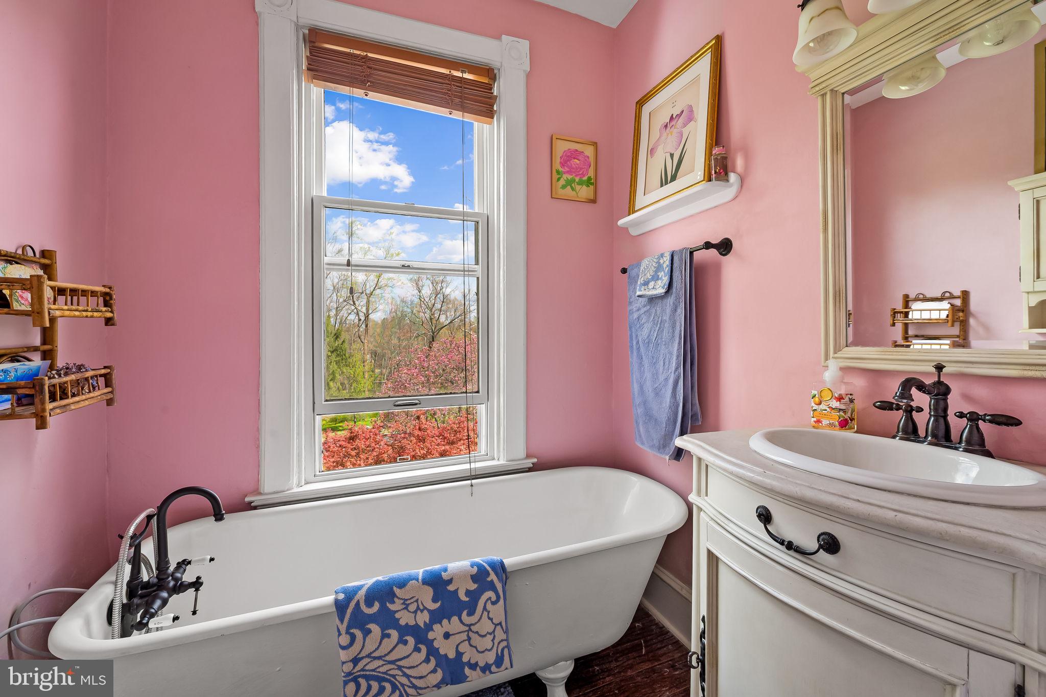 1018 Windsor Road Baltimore, MD 21208 - Photo 36 of 50 a bathroom with a sink a bathtub and a window
