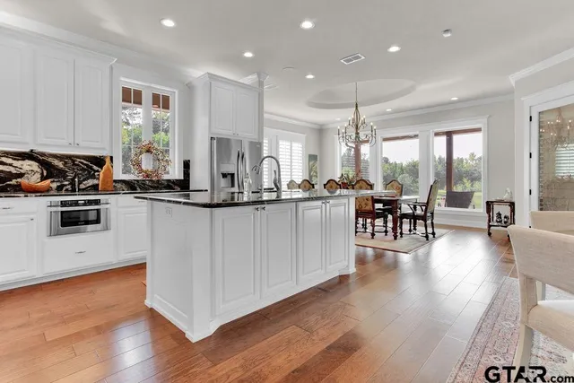 a kitchen with counter top space a sink appliances and cabinets