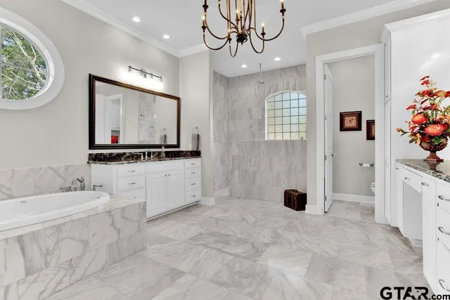 a view of a kitchen with a sink and chandelier