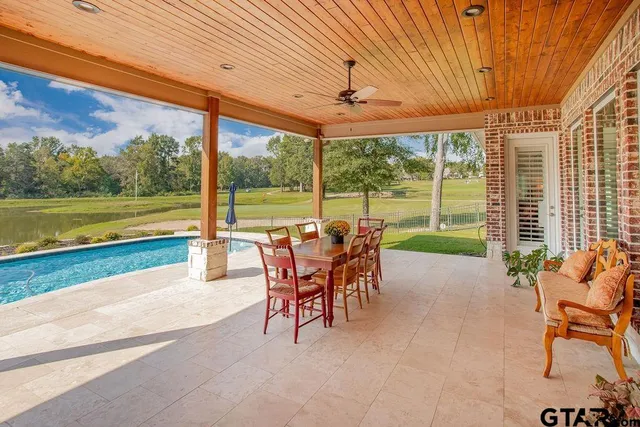 a view of a patio with a table chairs and a backyard