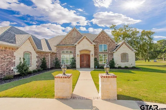 a front view of house with yard and swimming pool