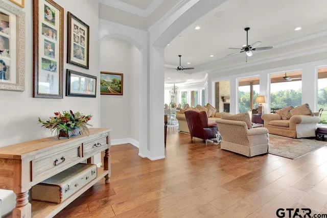 a living room with furniture and a chandelier